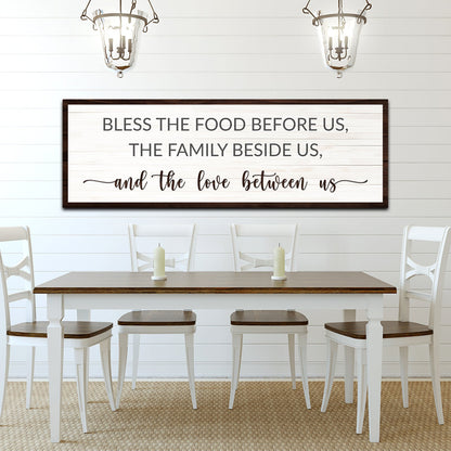 Style 2 of the Bless the Food canvas sign with a clean dark brown edge above a white dining table
