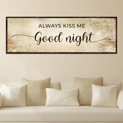 Always Kiss Me Good Night canvas sign in the warm beige style, hung above a cream sofa with pillows