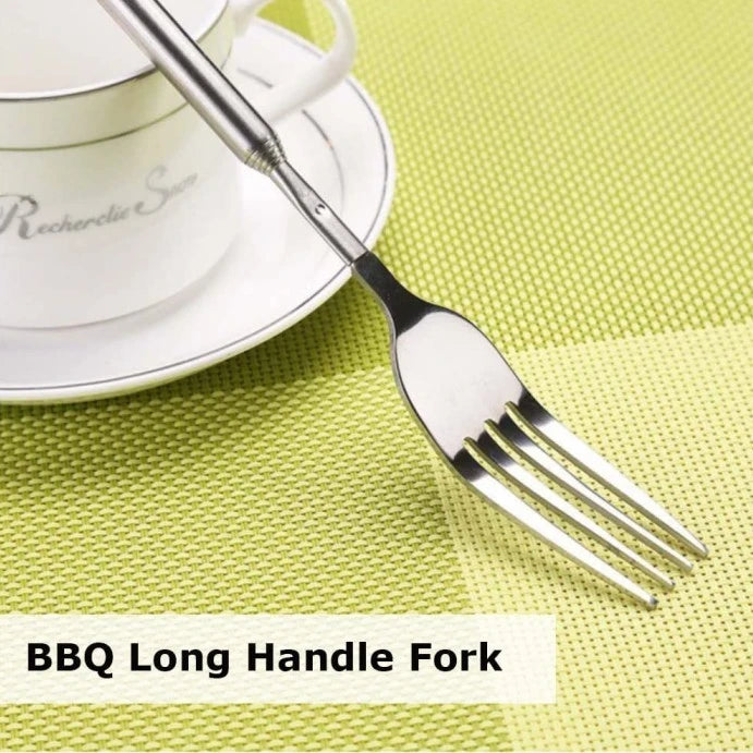 Telescopic BBQ fork extending to grab food from grill safely