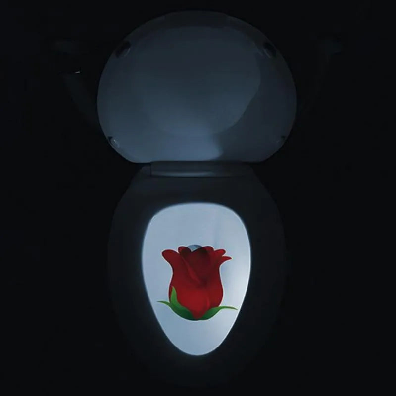 Toilet night light projecting red rose pattern in dark bathroom