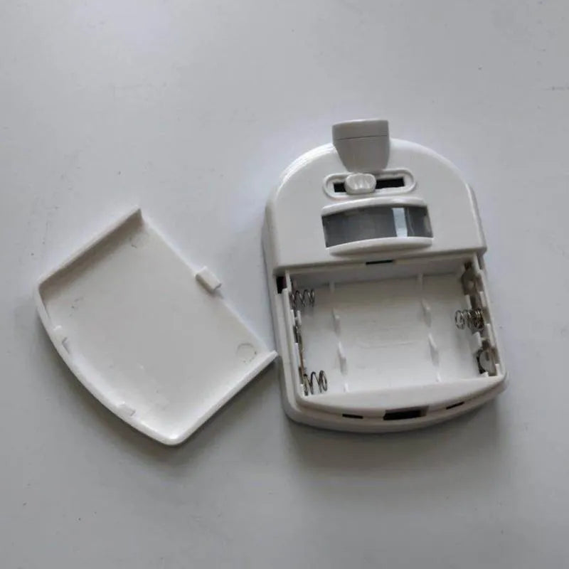 Toilet projection lamp opened showing battery compartment and removable cover