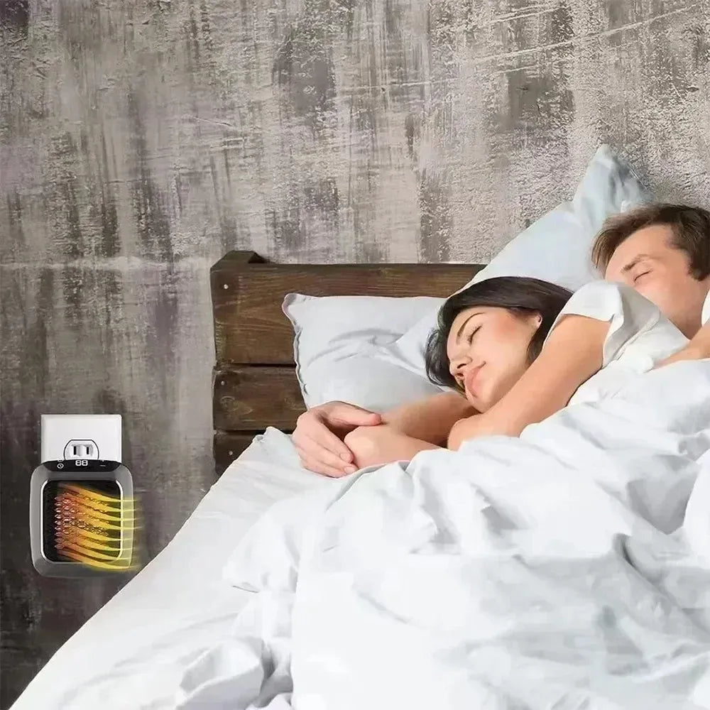 Two people sleeping in bed with a wall-mounted electric heater in the foreground.