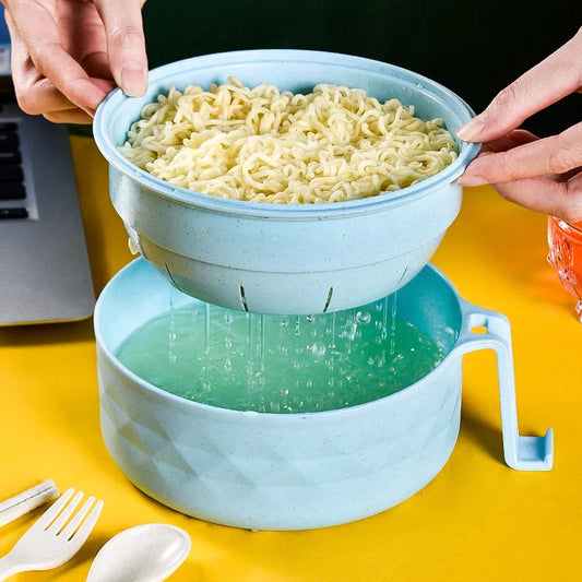 Wheat straw noodle bowl with built-in strainer draining cooked noodles over bowl