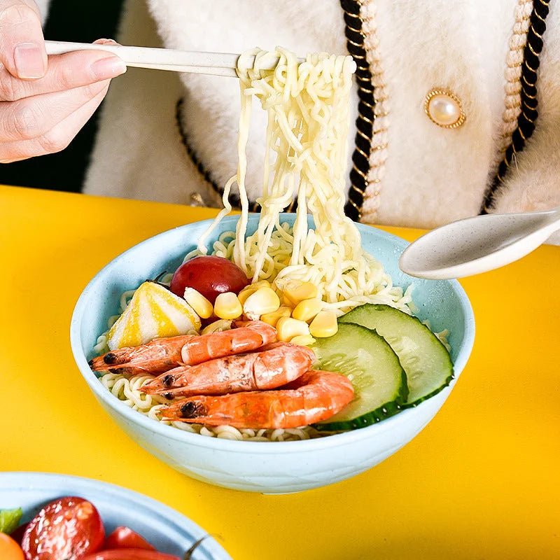 Wheat straw noodle bowl with shrimp, corn, cucumber and noodles served at dining table