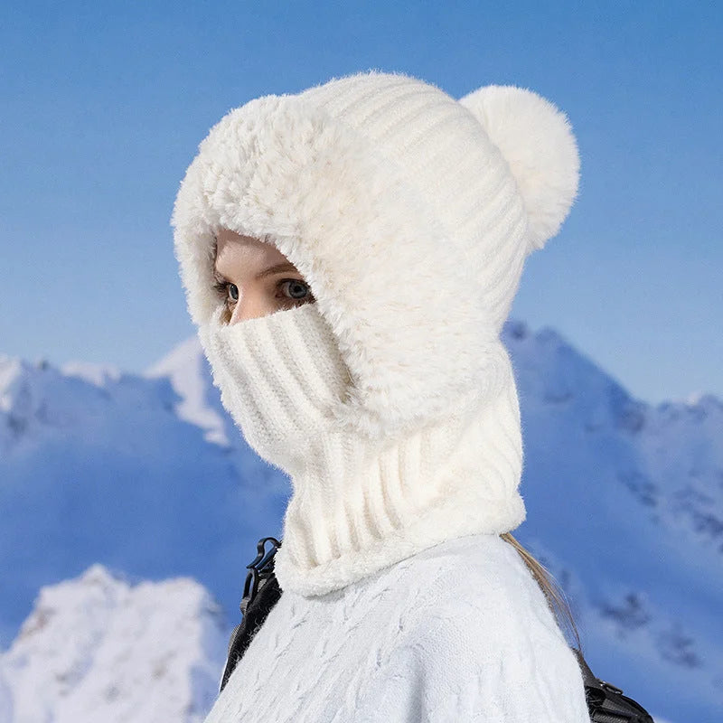White knitted winter hat scarf mask worn in cold mountain setting