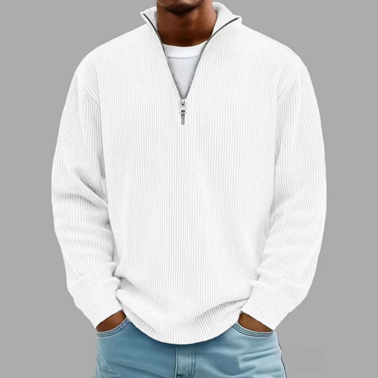 White ribbed sweater worn by a person on a gray background
