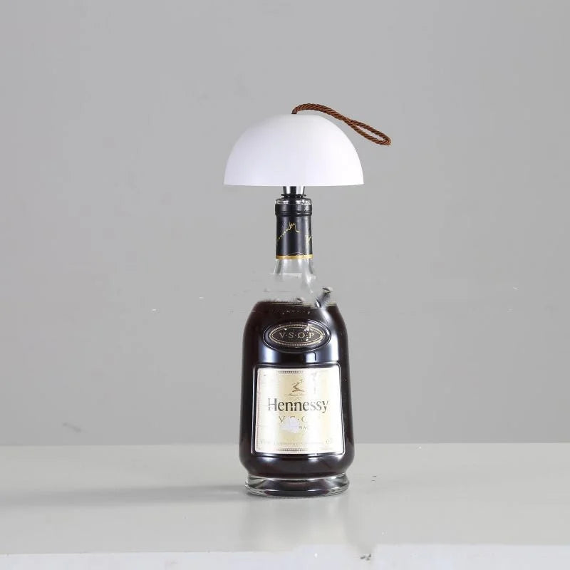 Wine bottle lamp with white dome shade creating soft ambient lighting
