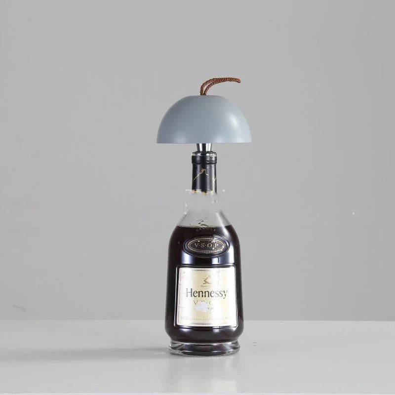 Wine bottle table lamp featuring light gray dome shade and minimalist design
