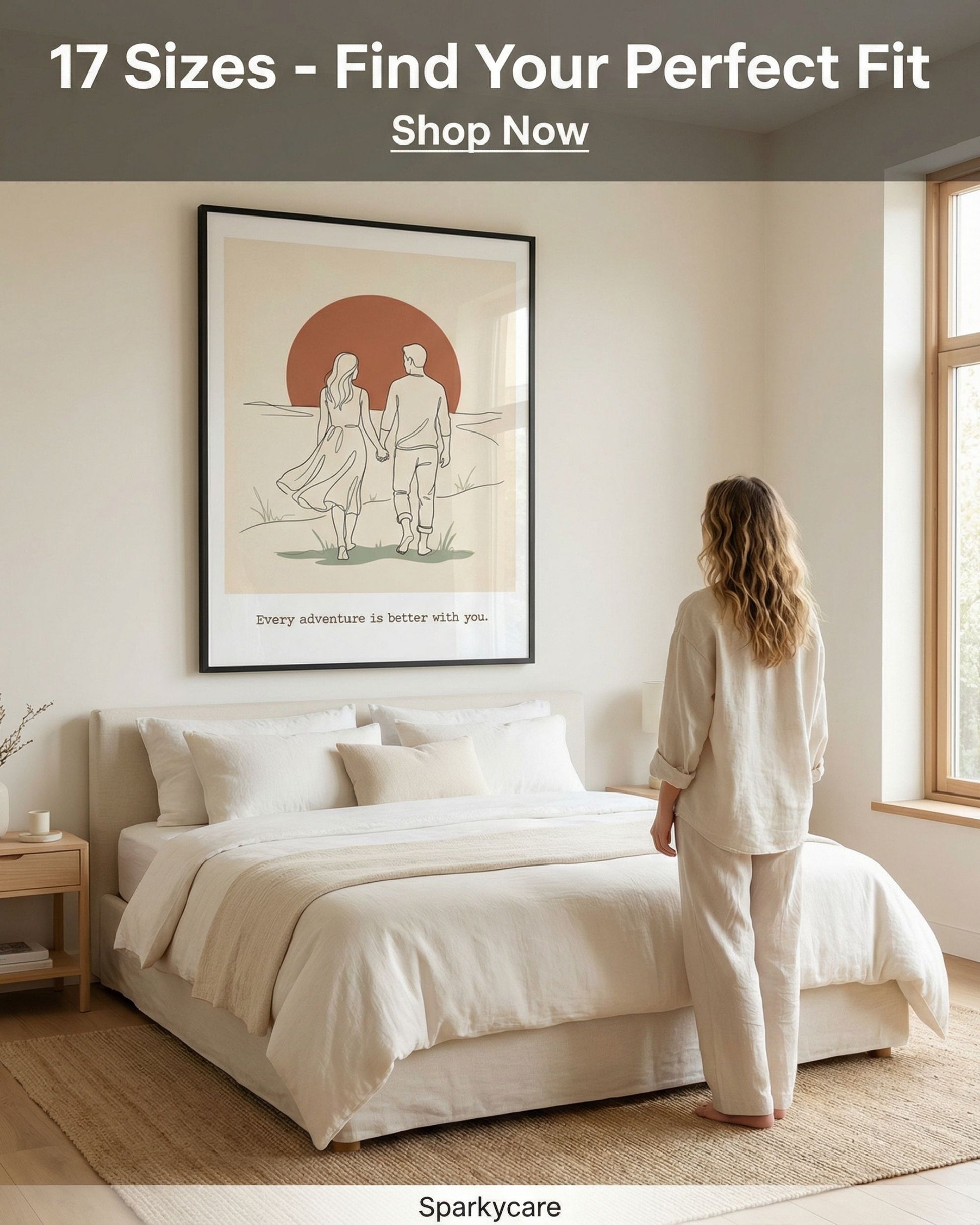 Woman in a bedroom looking at a framed artwork on the wall.