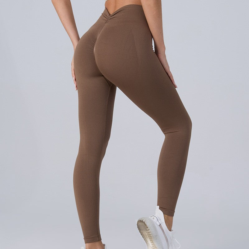 Woman in brown shapewear leggings showing slimming belly and foldable waist design
