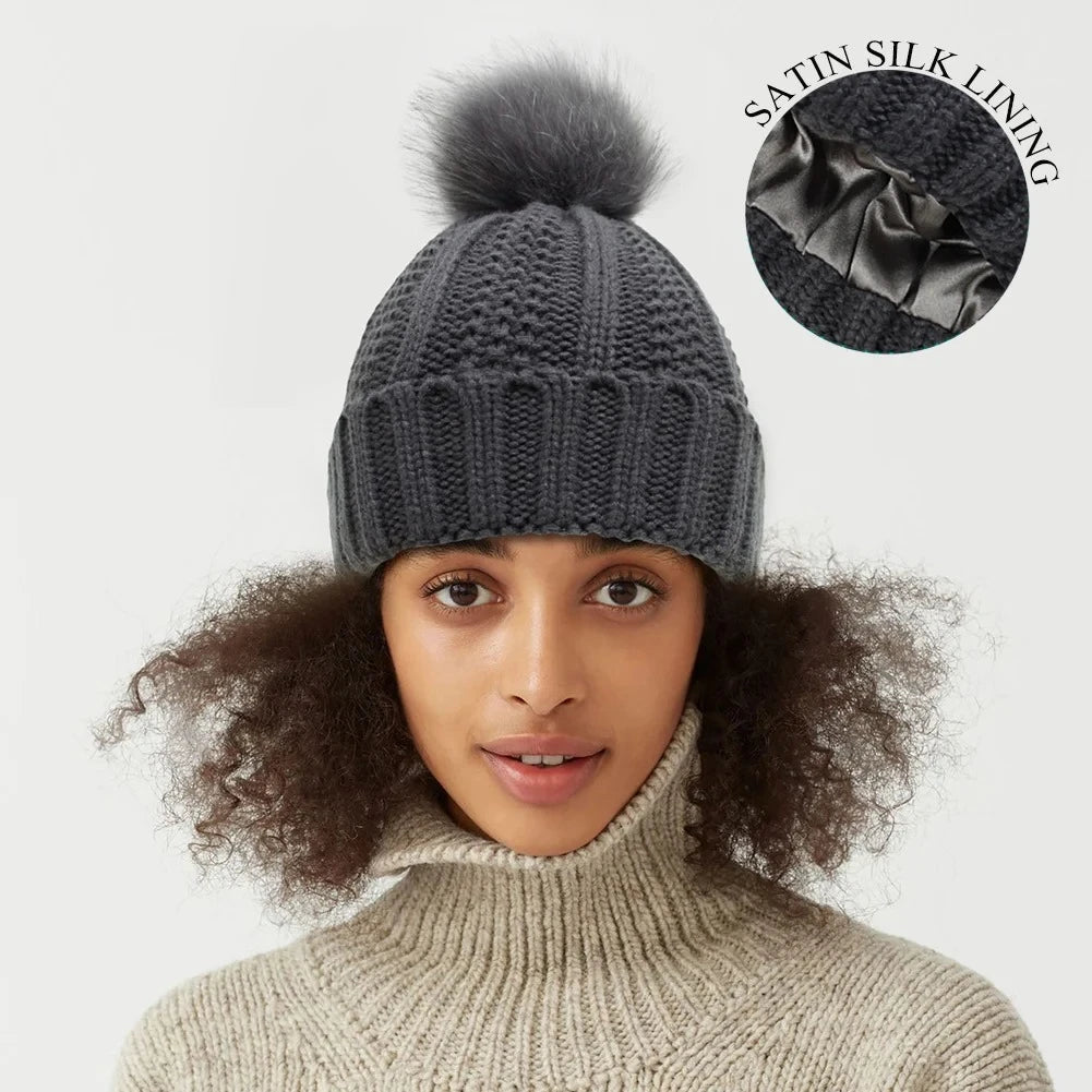 Woman wearing Gray knit beanie with silk satin interior lining protects hair from frizz perfect for curly hair