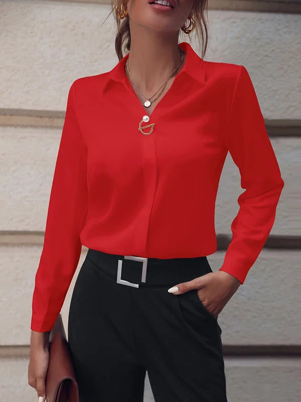Women’s red commuter blouse styled with a polished minimal look