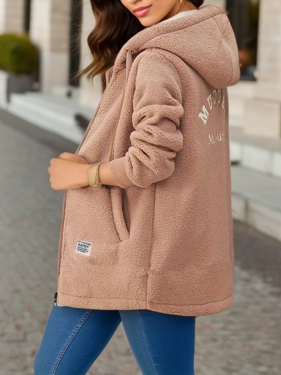Women’s tan fleece hooded jacket with embroidered back detail, designed for a stylish relaxed fit