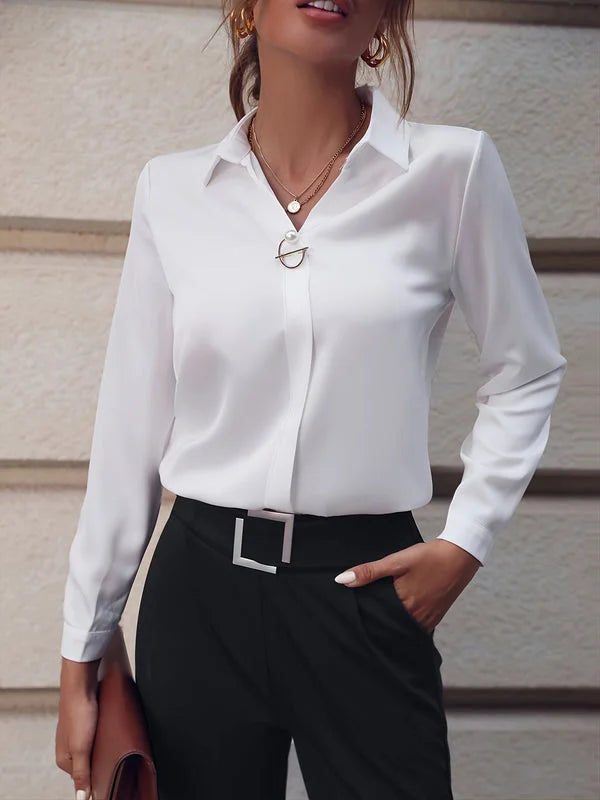 Women’s white commuter V-neck blouse paired with sleek black pants