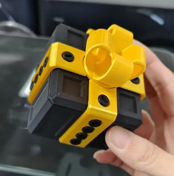 Yellow and black 3D printed Christmas gift box cube held in hand - funny matryoshka decor piece
