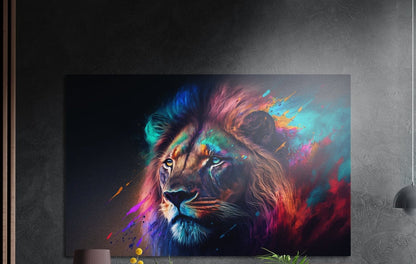 Lion with a teal and magenta paint splash mane brushed aluminum wall art on a dark gray wall above plants