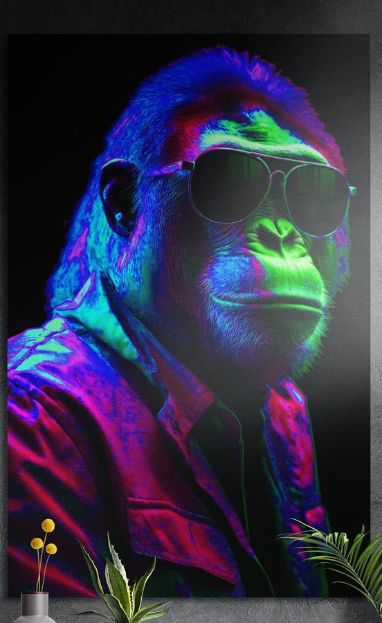 Neon gorilla in aviator sunglasses and a pink jacket, brushed aluminum wall art on a gray wall above a vase and plants