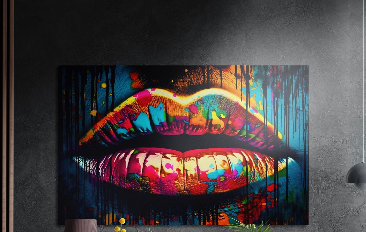 Rainbow drip lips pop art brushed aluminum wall art on a dark textured wall above a lamp, yellow flowers and plants