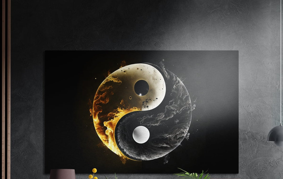 A gold and silver yin yang symbol wrapped in fire and smoke brushed aluminum wall art above yellow flowers and plants
