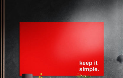 Keep it simple white text on red brushed aluminum wall art on a dark textured wall above potted plants