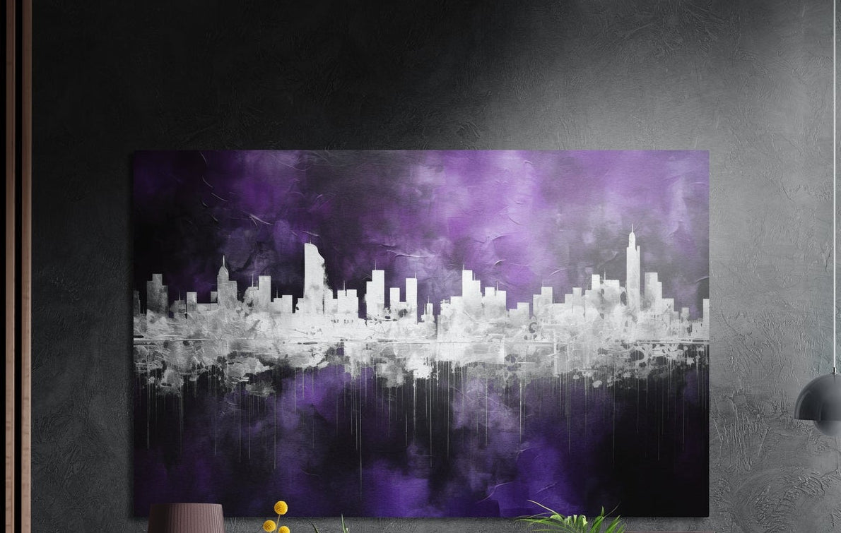 Silver city skyline on purple mist brushed aluminum wall art on a dark textured wall, a lamp and plant tops below