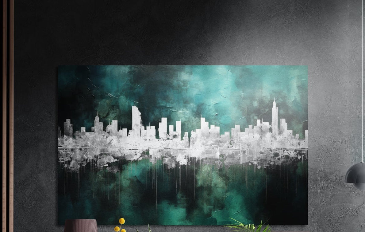 Silver city skyline on teal mist brushed aluminum wall art on a dark textured wall, a lamp and plant tops below