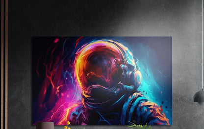 Neon astronaut helmet profile brushed aluminum wall art on a dark textured wall above a lamp and plants