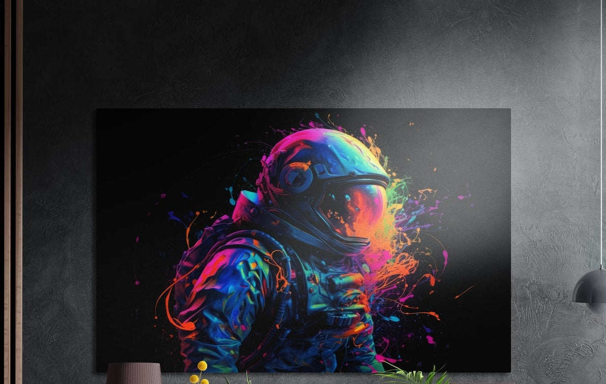 Rainbow burst astronaut on black brushed aluminum wall art on a dark textured wall above a lamp and plants