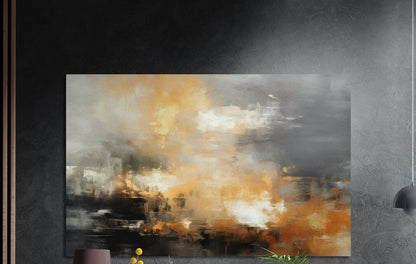 Smoky gray and amber abstract brushed aluminum wall art on a dark wall above a vase and plants