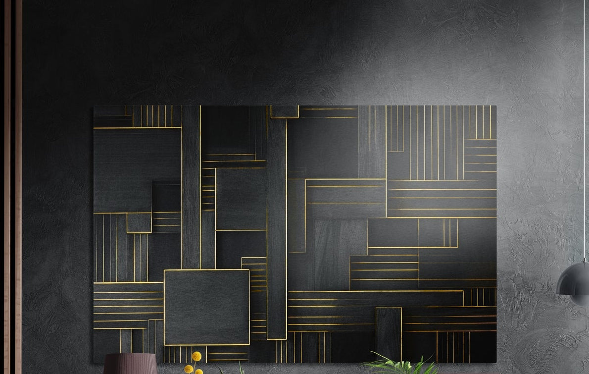 Gold line geometry on black brushed aluminum wall art on a dark gray concrete wall