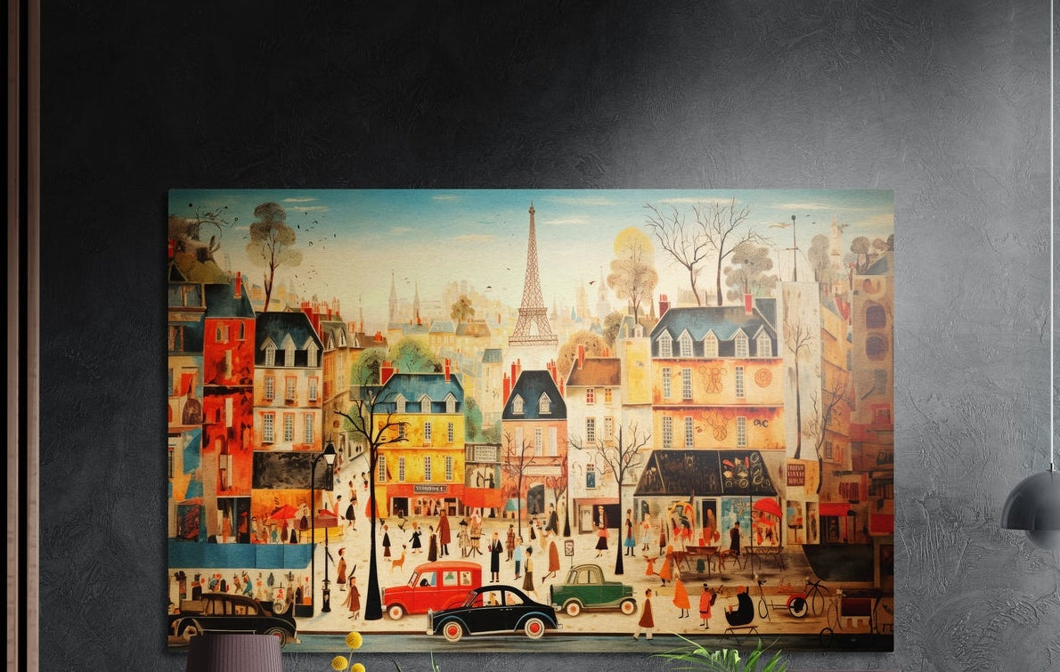 Whimsical Paris street scene brushed aluminum wall art on a dark textured wall, a lamp and plant tops below