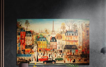 Whimsical Paris street scene brushed aluminum wall art on a dark textured wall, a lamp and plant tops below