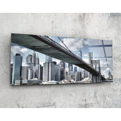 Brooklyn Bridge skyline panoramic glass wall art shown at an angle on a concrete wall