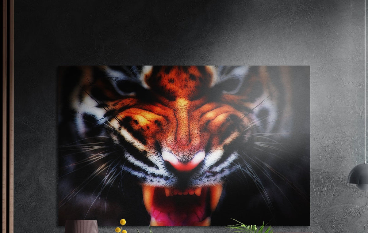 Snarling tiger face brushed aluminum wall art on a dark textured wall beside wood slats and a lamp