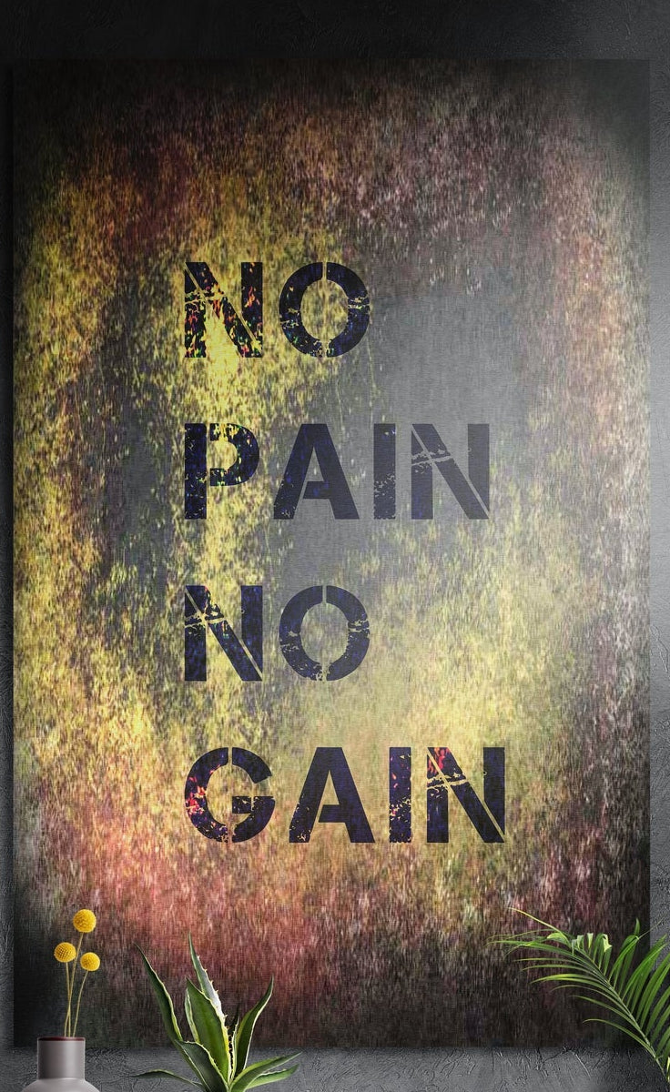 No pain no gain grunge stencil brushed aluminum wall art on a dark wall above yellow flowers and plants