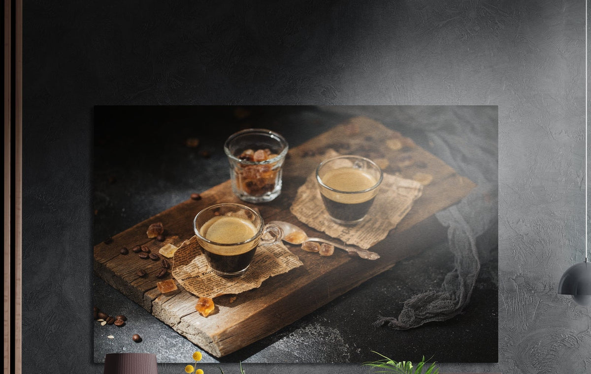 Espresso cups on a wooden board brushed aluminum wall art on a dark gray concrete wall