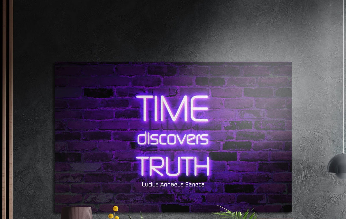 Purple neon quote brushed aluminum wall art on a dark textured wall with plants below