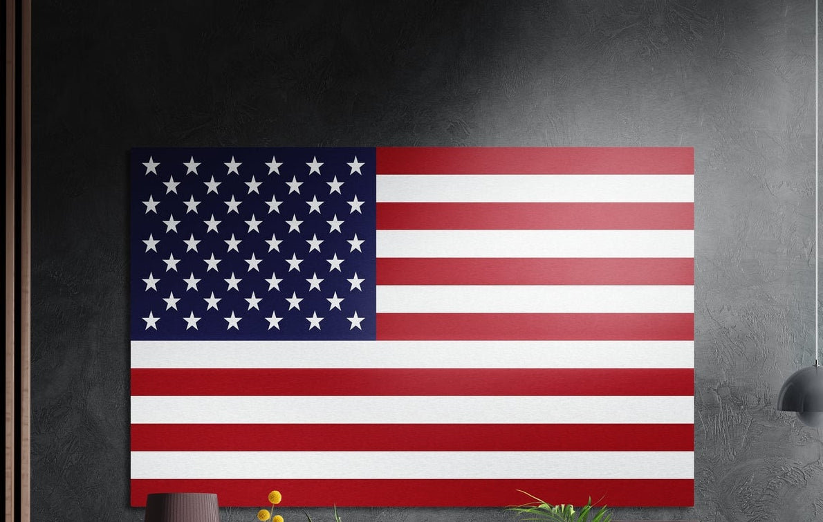 American flag with white stars on blue and red and white stripes, brushed aluminum wall art on a dark gray wall by wood slats