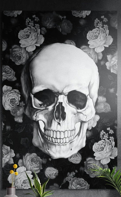 Black and white skull with roses brushed aluminum wall art on a gray concrete wall above small plants