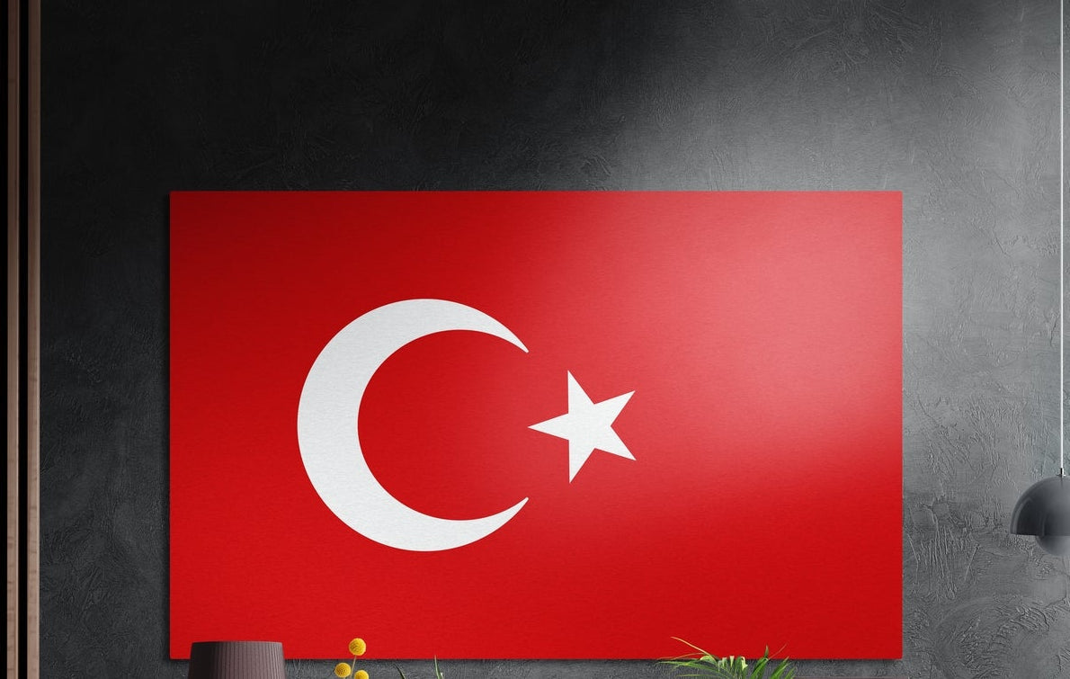 Turkey flag with a white crescent and star on red, brushed aluminum wall art on a dark gray wall by wood slats
