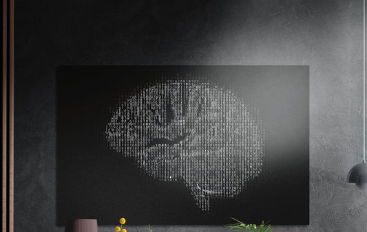 Binary code brain on black brushed aluminum wall art on a dark wall above a vase and plants