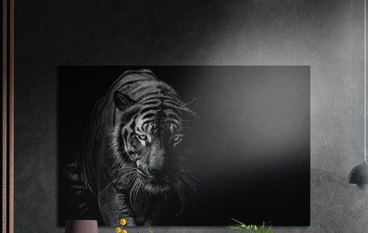 Black and white prowling tiger brushed aluminum wall art on a dark wall above a sideboard with yellow flowers