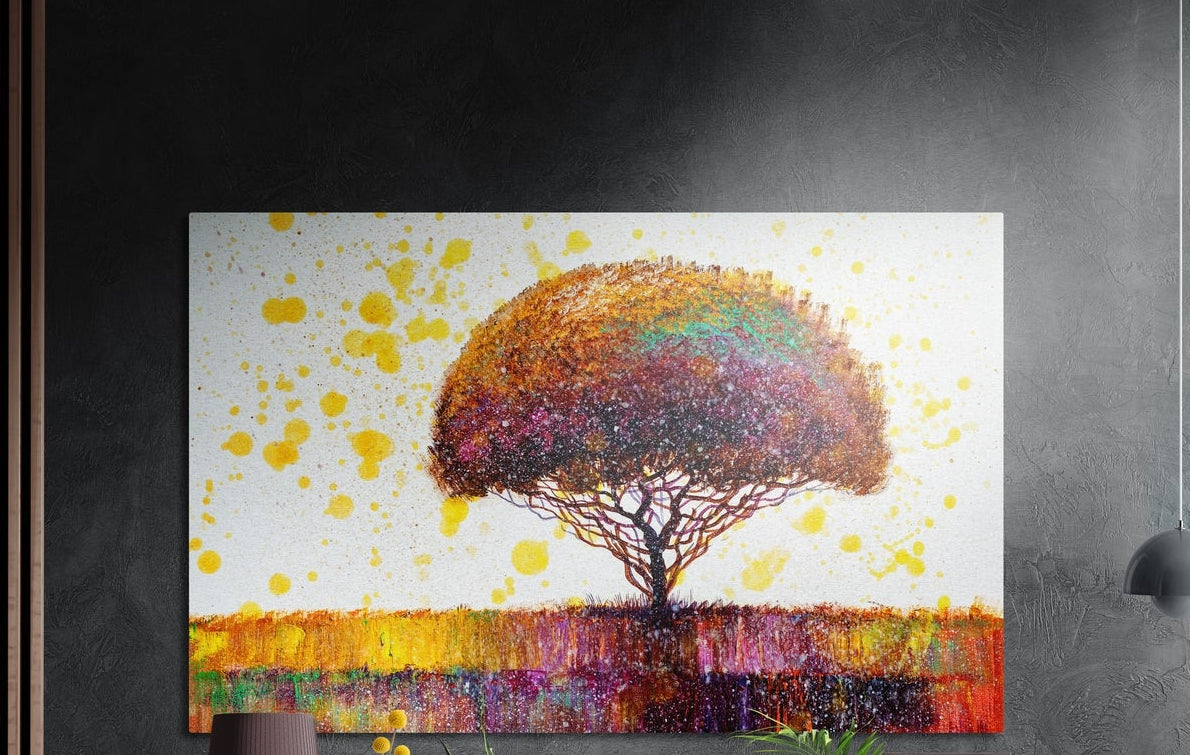 Rainbow lone tree brushed aluminum wall art on a dark gray wall above a sideboard with a vase and plants