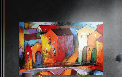 Colorful old town houses on a bridge brushed aluminum wall art on a dark textured wall beside wood slats and a lamp