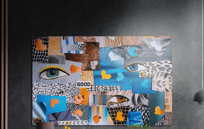 Blue paper collage eyes and hearts brushed aluminum wall art on a dark textured wall above a lamp, flowers and plants