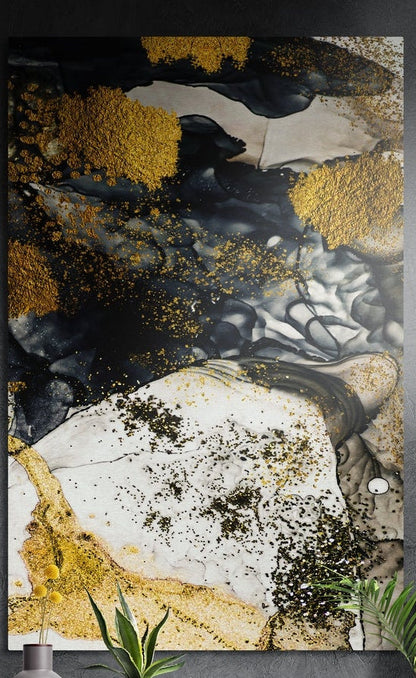 Black cream and gold marble swirl brushed aluminum wall art on a gray wall above yellow flowers and plants
