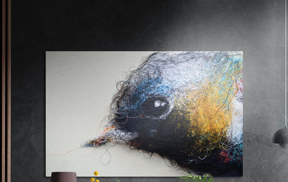 Sparrow made of tangled colored threads on a pale background brushed aluminum wall art on a dark gray wall above plants