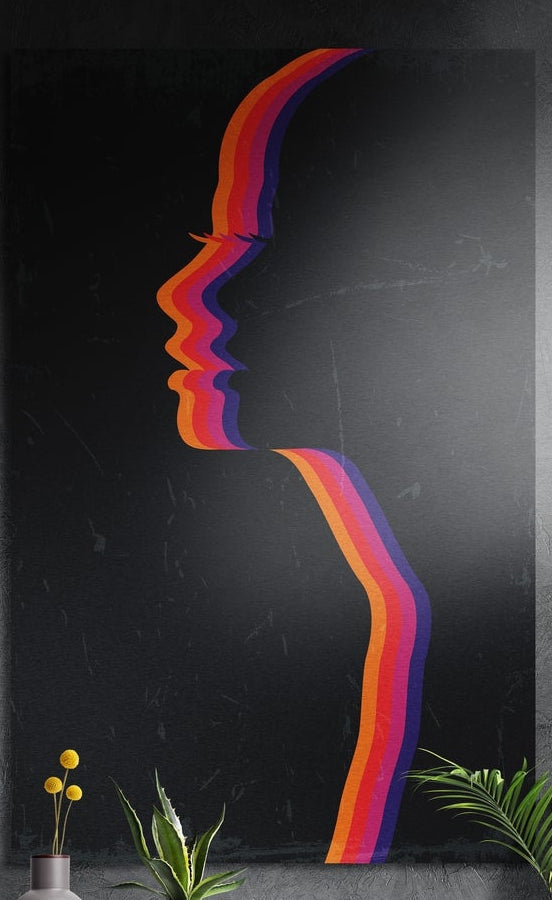 Rainbow stripe face profile on dark marble, brushed aluminum wall art on a dark gray wall above yellow flowers