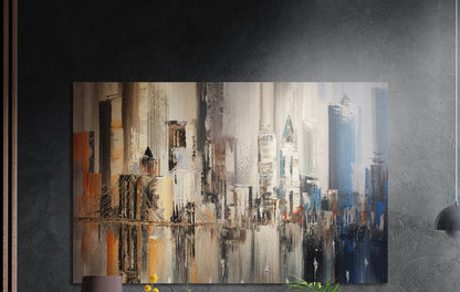 Abstract earth tone city skyline brushed aluminum wall art on a dark textured wall beside wood slats and a lamp