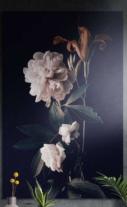 White peony brushed aluminum wall art on a dark gray wall with plants in front of its lower edge